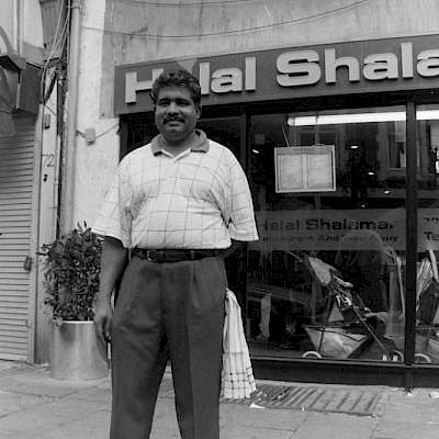 Restaurant staff standing in front of Halal Shalamar Restaurant.